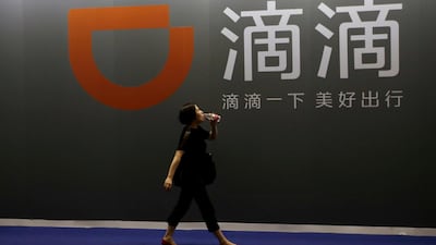 A woman walks past ride-hailing company Didi Chuxing's booth at the Global Mobile Internet Conference 2017 in Beijing. The company is gearing up for a battle to knock Uber off its perch in Mexico. Jason Lee/Reuters