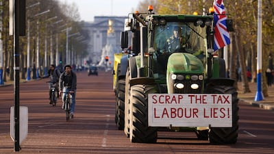 A tractor drives through central London as farmers protest. PA