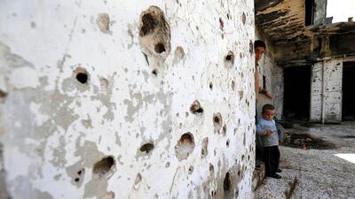 Syrian boys are seen inside their destroyed house in the neighbourhood of Baba Amr in Homs, Syria. A successful truce will create a more favourable backdrop for peace talks that collapsed in acrimony in early February as a Russia-backed regime offensive in northern Syria caused tens of thousands to flee. Hassan Ammar / AP