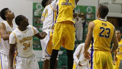 Montverde Academy’s Marquez Letcher-Ellis, centre, grabs a rebound over several Simeon players during their game at the Al Shabab Sports Club in Mamzar on Tuesday. Simeon won, 98-78. Antonie Robertson / The National