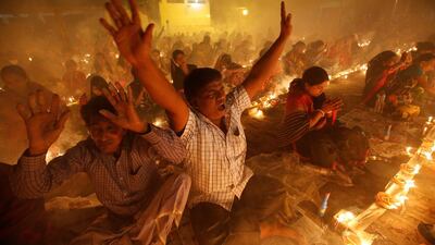 Hindu devotees react as they sit together on the floor of a temple to observe Rakher Upabash, in Narayangonj near Dhaka, Bangladesh. Mohammad Ponir Hossain / Reuters