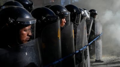 Police advance on a group of teachers protesting against forced retirement in La Paz, Bolivia. AP