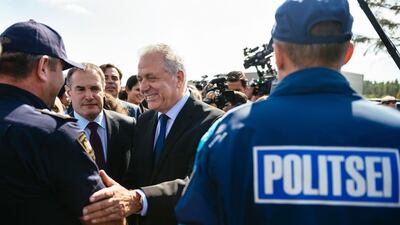 European Union commissioner for migration Dimitris Avramopoulos (C) shakes hands with European Border and Coast Guard Agency (EBCG) officials on October 6, 2016, at the Kapitan-Andreevo checkpoint on the Bulgaria-Turkey border. Dimitar Dilkoff/AFP