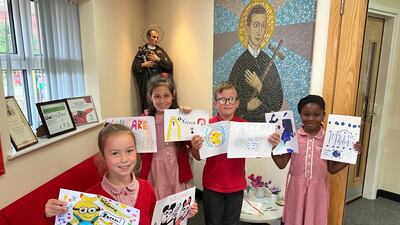 Pupils from St Gerard's Catholic Primary School in Birmingham with their hand-drawn pictures. PA