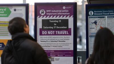 Signs warn of railway travel disruption ahead. EPA