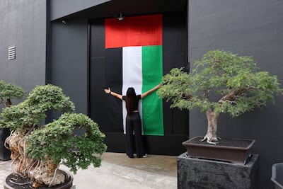 A UAE flag adorns the door of Bocasu Specialty Coffee in Al Quoz, Dubai. Chris Whiteoak / The National