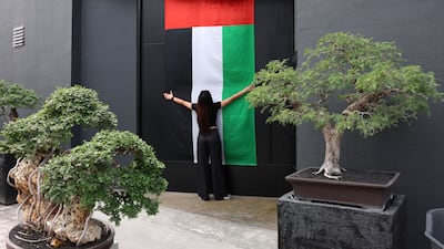 A flag on the door of Bocasu Specialty Coffee in Al Quoz, Dubai. Flags have been hung across the Emirates to display national pride. Chris Whiteoak / The National