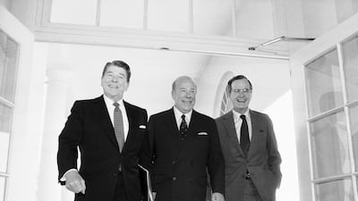 Secretary of State George Shultz walks between President Ronald Reagan and Vice President George Bush at the White House on January 9, 1985 after two days of arms talks with the Soviet Union in Geneva. AP