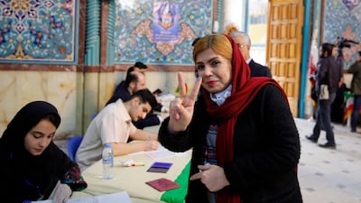An Iranian woman flashes the victory sign after casting her ballot at a polling station during the parliamentary elections in Tehran. EPA