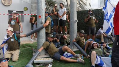 People chain themselves together outside Israel's Ministry of Defence building in Tel Aviv, in a 'Day of National Resistance' protest. Reuters