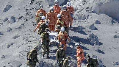 Japan Self-Defence Force (JSDF) soldiers and firefighters carry an injured person near a crater of Mount Ontake, which straddles Nagano and Gifu prefectures as more than 500 Japanese military and police set out on Sunday to search the peak of a volcano popular with hikers a day after its sudden eruption trapped hundreds on the mountain for hours, amid conflicting reports about missing and injured climbers. Reuters
