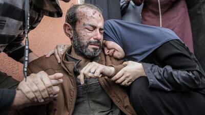 People grieve for Palestinians killed in air strikes on Sunday in Khan Younis, Gaza. Getty