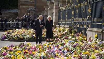 King Charles and the Queen Consort Camilla view floral tributes left outside Hillsborough Castle. PA