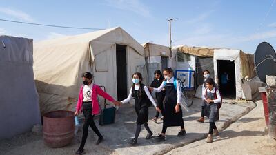 Girls walk to class on the first day of school in a camp for displaced Yazidi people in the Sharya area, about 15 kilometres from Dohuk, in the autonomous Iraqi Kurdistan region.