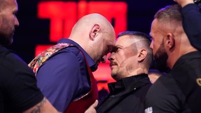 Tyson Fury moves his head towards Oleksandr Usyk as the face off gets heated. PA