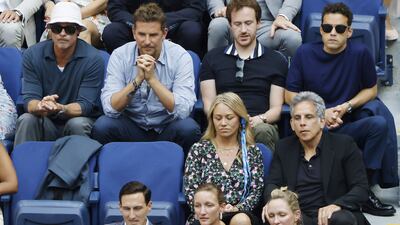 US actors Brad Pitt, top left, Bradley Cooper, Rami Malek, Christine Taylor, front left, and Ben Stiller watch Daniil Medvedev of Russia play Novak Djokovic of Serbia. EPA