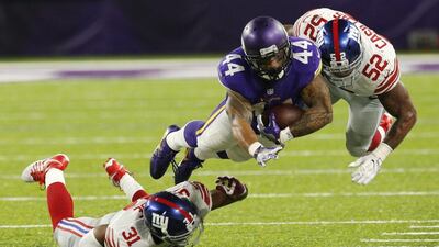Minnesota Vikings running back Matt Asiata dives for extra yardage against the New York Giants on Monday night. Jim Mone / AP