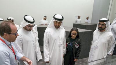 Sheikh Mohammed bin Rashid, right, Sheikh Mohammed bin Zayed, centre and Alia Al Mansoori, centre right, are given a tour of the artwork with Mohammed Khalifa Al Mubarak, chairman of Abu Dhabi Tourism and Culture Authority, tour the Louvre Abu Dhabi. Mohamed Al Hammadi / Crown Prince Court - Abu Dhabi