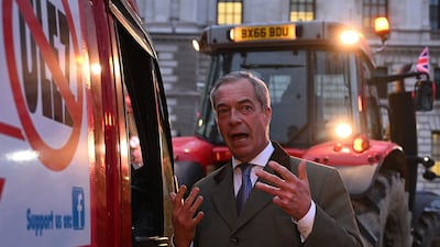 Nigel Farage speaks to the driver of a van taking part in a protest against the Ulez charge while ahead of him farmers drive tractors near the Houses of Parliament. Getty Images