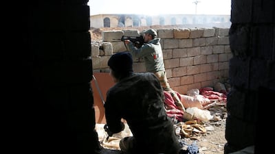 Iraqi security forces fire at targets during clashes with Islamic State militants, north of Mosul, Iraq.