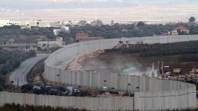 Israeli military diggers work on the Lebanese-Israeli border next to a wall that was built by Israel in the southern village of Kafr Kila, Lebanon, Tuesday, Dec. 4, 2018. The Israeli military launched an operation on Tuesday to "expose and thwart" tunnels it says were built by the Hezbollah militant group that stretch from Lebanon into northern Israel. (AP Photo/Mohammed Zaatari)