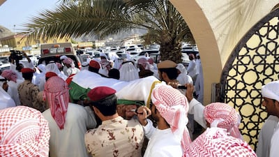 The body of Warrant Officer Mohammed Saeed Al Hassani is carried for burial in Fujairah on Saturday. Wam
