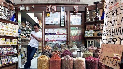 A vendor awaits customers at the spice souk in Deira, Dubai. The election of a new reform-minded president in Iran should boost trade with the UAE. Jumana El Heloueh / Reuters