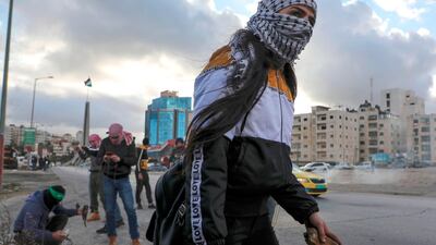 A Palestinian demonstrator looks on during clashes with Israeli security forces following rally protesting a US peace plan proposal, at the northern entrance of the West Bank city of Ramallah near the Jewish settlement of Beit El, on February 1, 2020. AFP