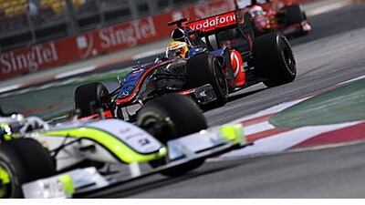 Lewis Hamilton trails a BrawnGP car during practice in Singapore.