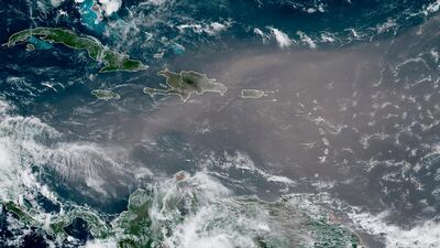 This satellite photo provided by the National Oceanic and Atmospheric Administration shows a cloud of dust coming from the Sahara over to the Caribbean. NOAA via AP