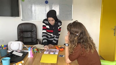 Arabic teacher Ana with a student at the Misbah Centre. Amy McConaghy / The National