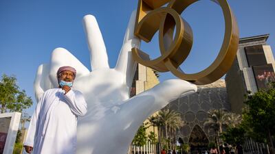 Visitor poses for a picture beside the installation in celebration of the UAE's 50th National Day. Image: Expo 2020 Dubai