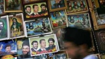 Radical chic: posters of Ahmadinejad, Assad and Nasrallah outside the Sayyida Zeinab Shrine in Damascus.