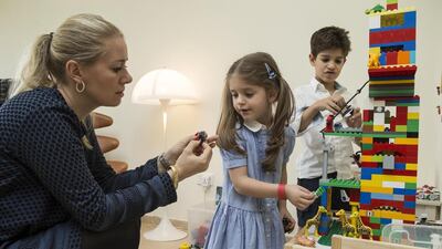 Kristina Kunz Kharazmi collects Lego and Duplo blocks for underpriviliged children in the Philipines. She is pictured here with her son Alexander and daughter Izabella. Antonie Robertson / The National