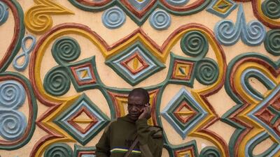 A police officer talks on his phone outside the Emir of Zaria’s palace in Zaria.