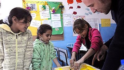 Michael Cooper, the head of the art programme at Repton School in Dubai, conducts a lesson at Hermann Gmeiner School in Bethlehem on Wednesday. Twelve volunteers took part in the Start project.