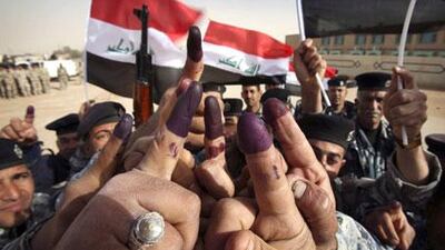 "Iraqi security forces took the lead" as Iraqis went to the polls: police in Najaf raise their inked fingers after voting.