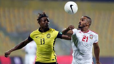 Mahmoud Khamis of the UAE battles for possession with Malaysia's Mohamadou Sumareh. Chris Whiteoak / The National