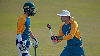 Pakistan's batting coach Younis Khan gives tips to Fawad Alam during a practice session at the Rawalpindi Cricket Stadium on Monday. AFP