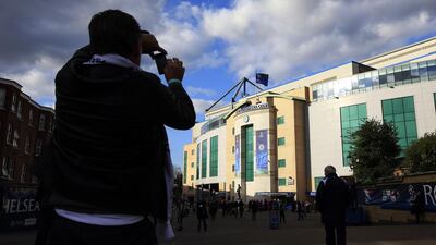 A football fan takes a picture of the outside of Stamford Bridge ahead of Tuesday night's Champions League match between Chelsea and Paris Saint-Germain. Adrian Dennis / AFP / April 8, 2014