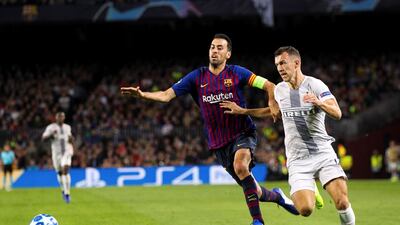 Barcelona midfielder Sergio Busquets, left, tussles with Inter Milan's winger Ivan Perisic at Camp Nou. Barcelona won the Uefa Champions League Group B match on Wednesday 2-0. EPA
