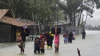 Bangladeshi villagers head for shelter in Cox’s Bazar on Saturday as Cyclone Roanu approached. AFP