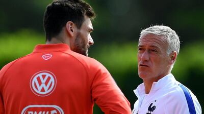 France manager Didier Deschamps, right, in comments attributed to his lawyer said that he will sue former France teammate Eric Cantona for slander. Franck Fife / AFP