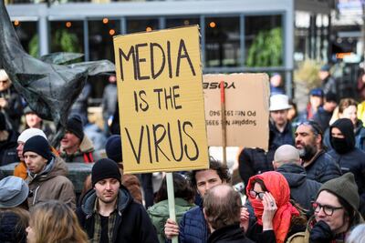 Protesters hold placards during a demonstration to oppose government restrictions to curb the spread of Covid-19, in Stockholm, Sweden. AP