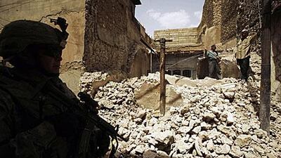 An American soldier patrols the streets in Mosul. This summer soldiers were pulled from iraq's cities, mostly confined now to their bases.
