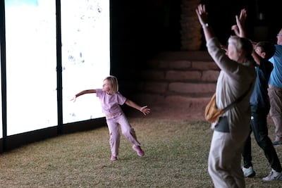 Visitors dance in front of the installation In Light, Together by the artist Alexandra Gelis. Getty Images