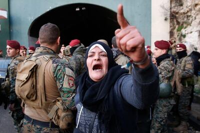 An anti-government protester shouts slogans as Lebanese army soldiers reopen a major highway that links the capital Beirut to northern Lebanon. AP Photo