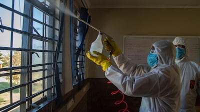 A disinfection team sprays inside a classroom at Ivory Park Secondary School east of Johannesburg, South Africa. AP Photo