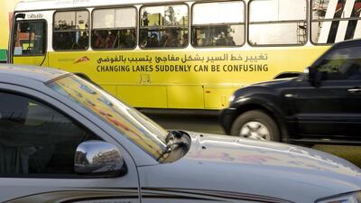 Simple messages, such as a sign on the side of a city bus, are part of the awareness campaign for safe driving. Jeff Topping / The National
