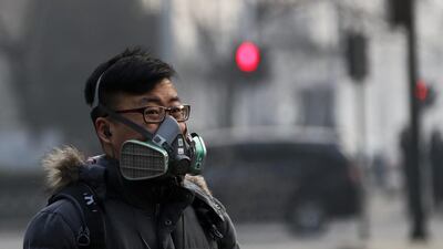 A man wearing a protective mask in Beijing on December 30, 2016. The Beijing Municipal Environmental Protection Bureau has extended an “orange alert” for heavy air pollution for three more days. Andy Wong / AP Photo